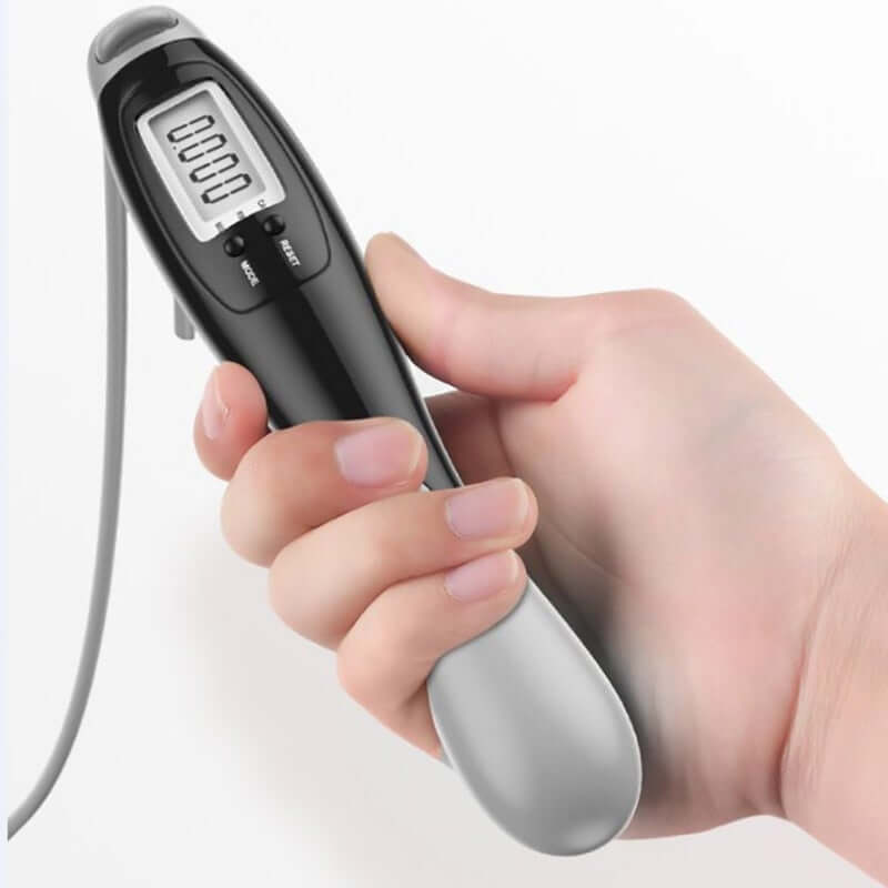 Digital cordless jump rope held in hand, featuring timer and calorie count display.